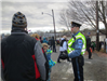 Police Officer in uniform with crowd of people in winter