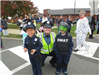 Officer smiling with two children in police costumes