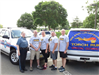 Five officers standing in front of a truck with torch Run sign on it