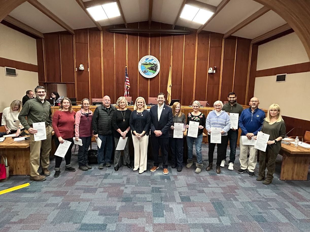 Photo contest winners with Mayor Peters-Manning and Deputy Mayor Chait in front of the dais