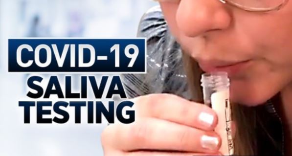 Woman spitting in a test tube for a COVID 19 test