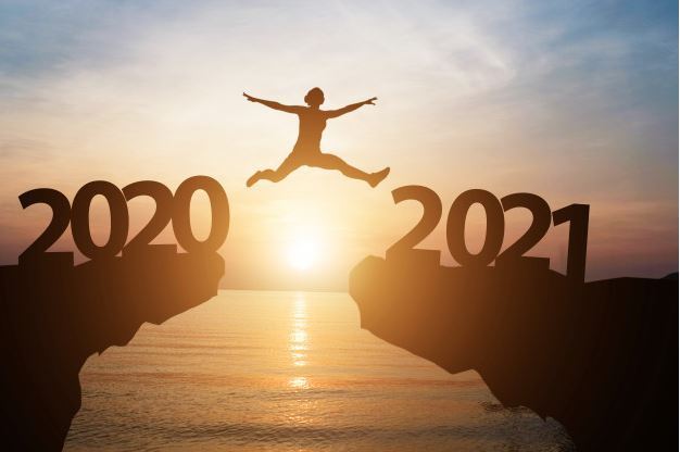 Image of a person jumping from one hill marked 2020 to another marked 2021, with a sunset and an oce