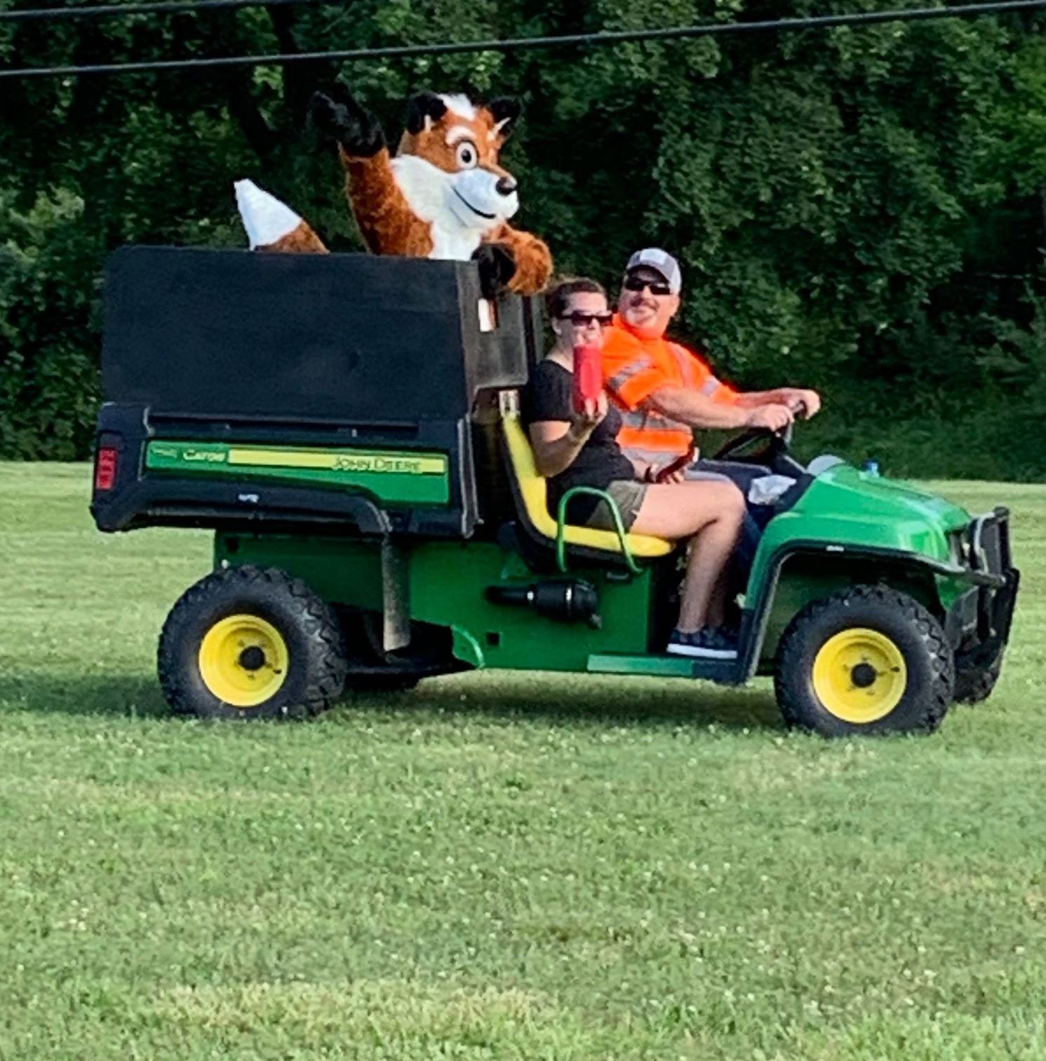 Fox mascot riding in on tractor