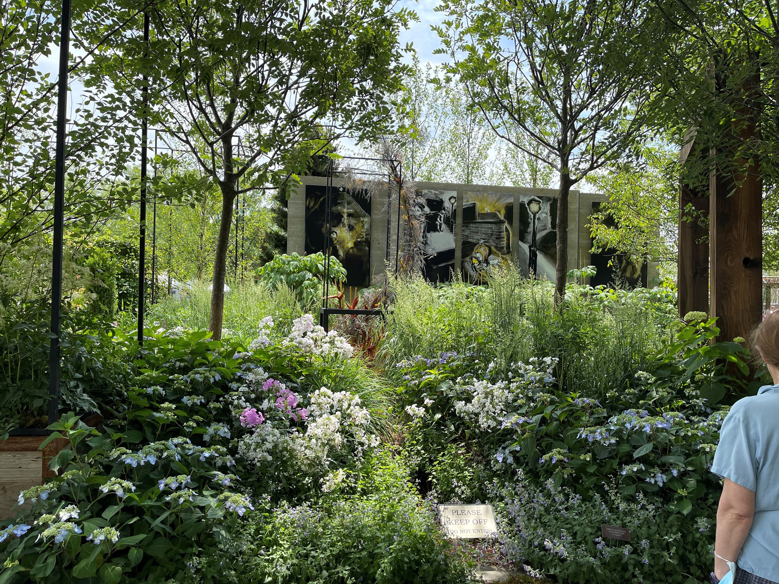 hill filled with flowers and abstract art in the back