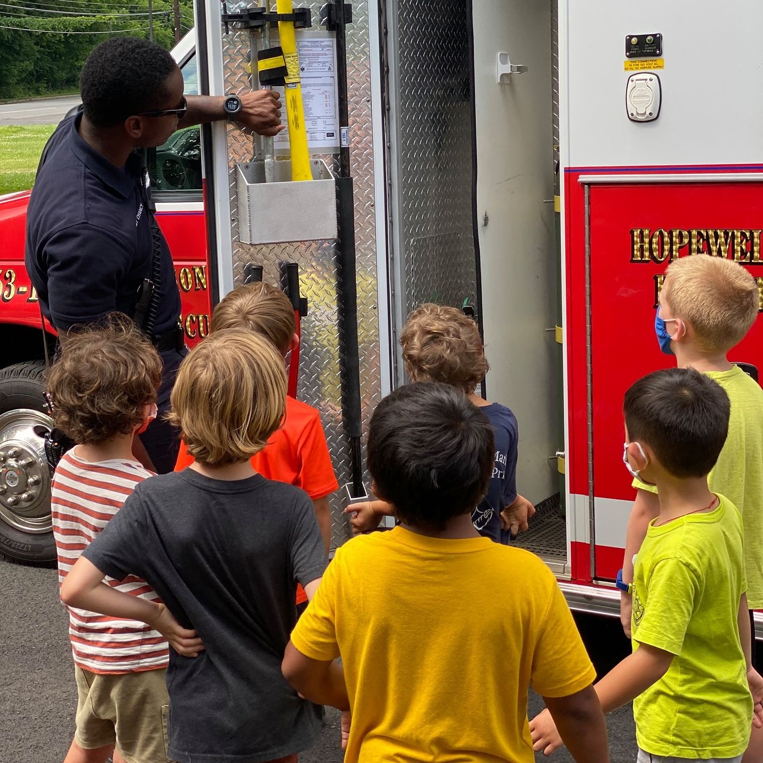 fireman showing children the truck