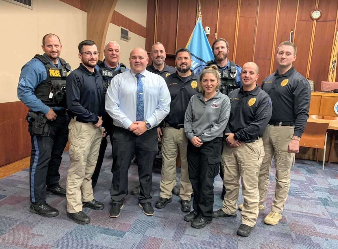Police Chief Rosso Surrounded by members of the police department in Township auditorium