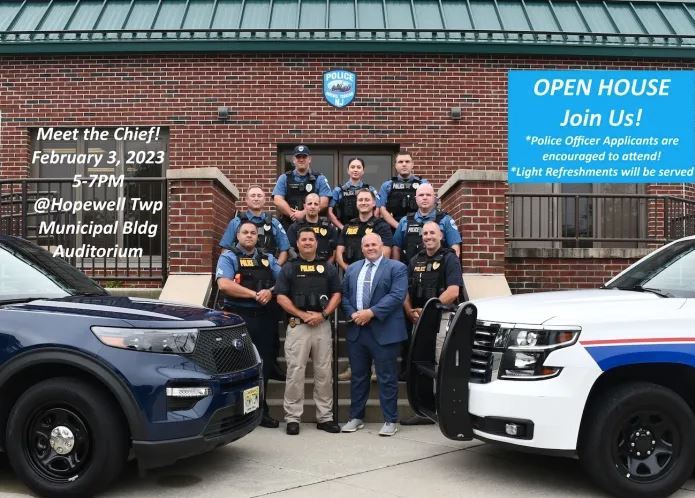 Police dept Open house with Chief surrounded by officers on the steps of the Police Department