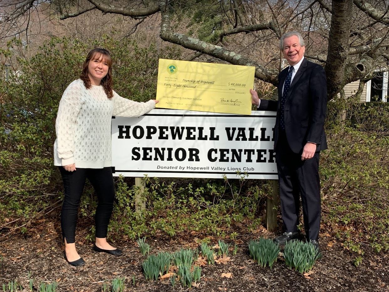 Senior Center sign with a big check for $48,000 and Mayor Ruger and Randi Malkiewicz of Senior Servi