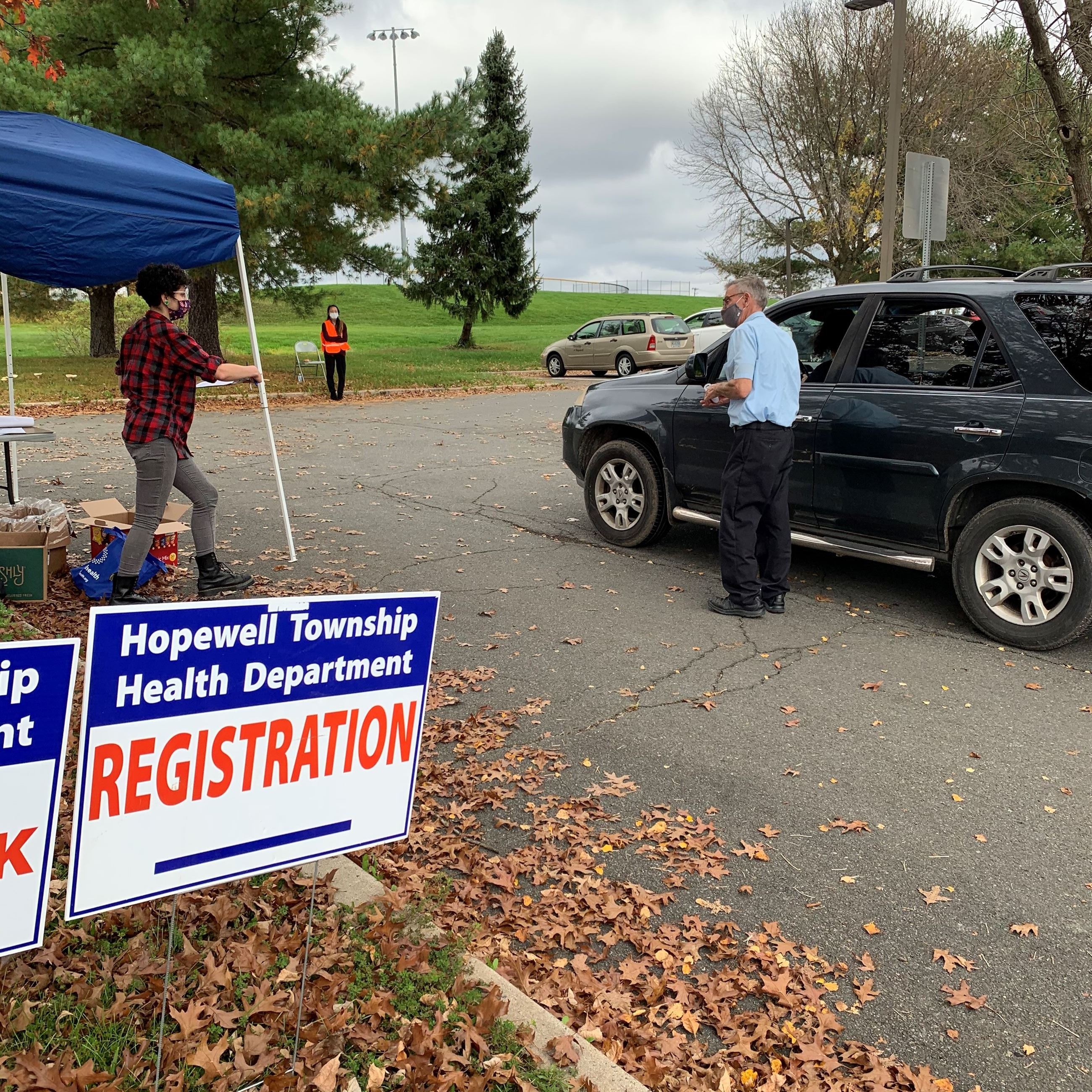 Hopewell Township Health Department Registration sign in front of a person waiting in line