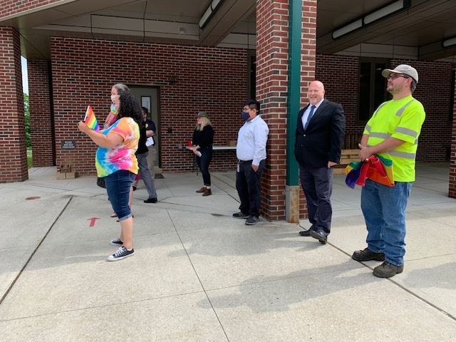 Community turns out for the raising of the Pride Flag