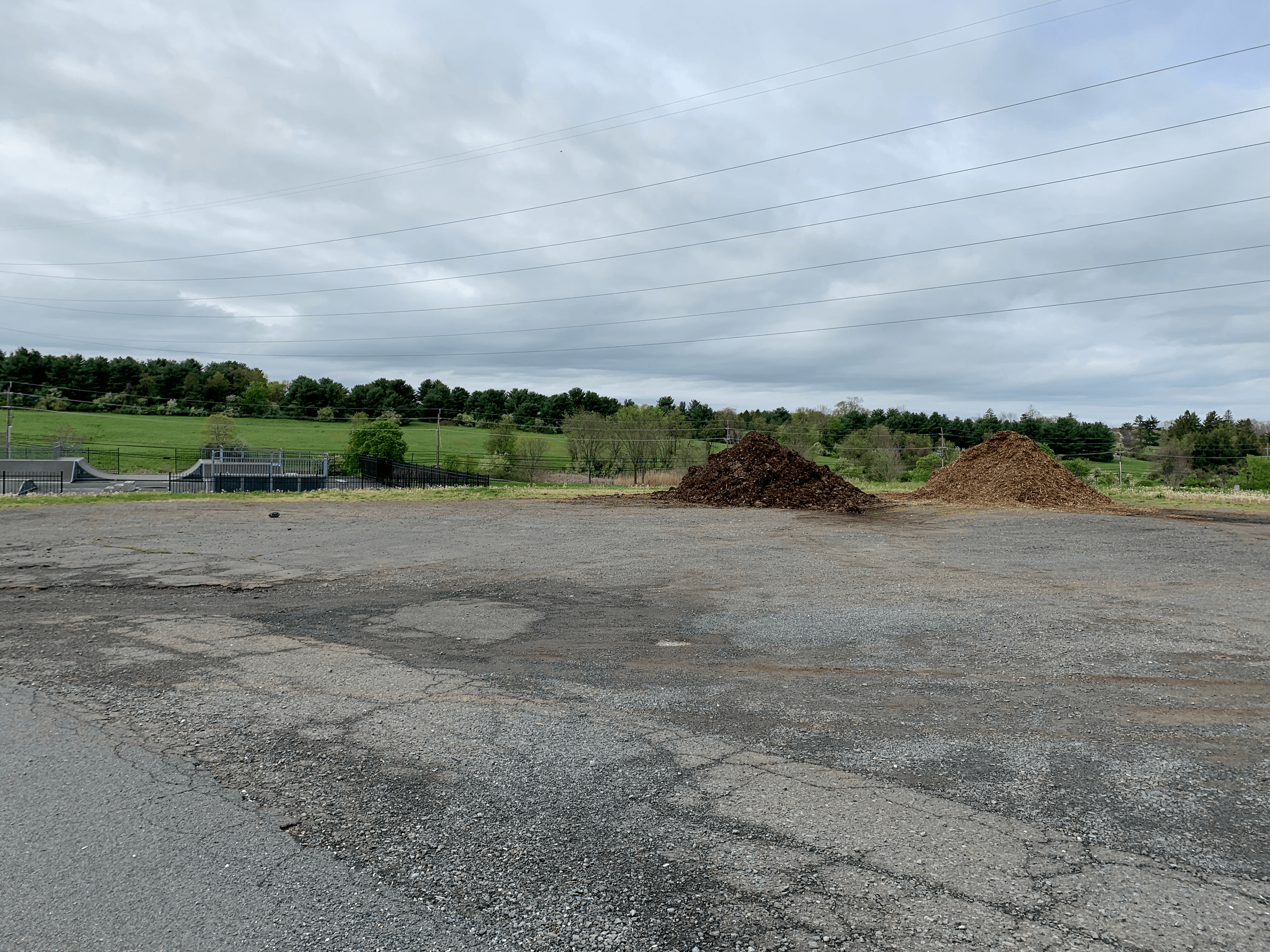 mulch pile in a parking lot next to the skate park
